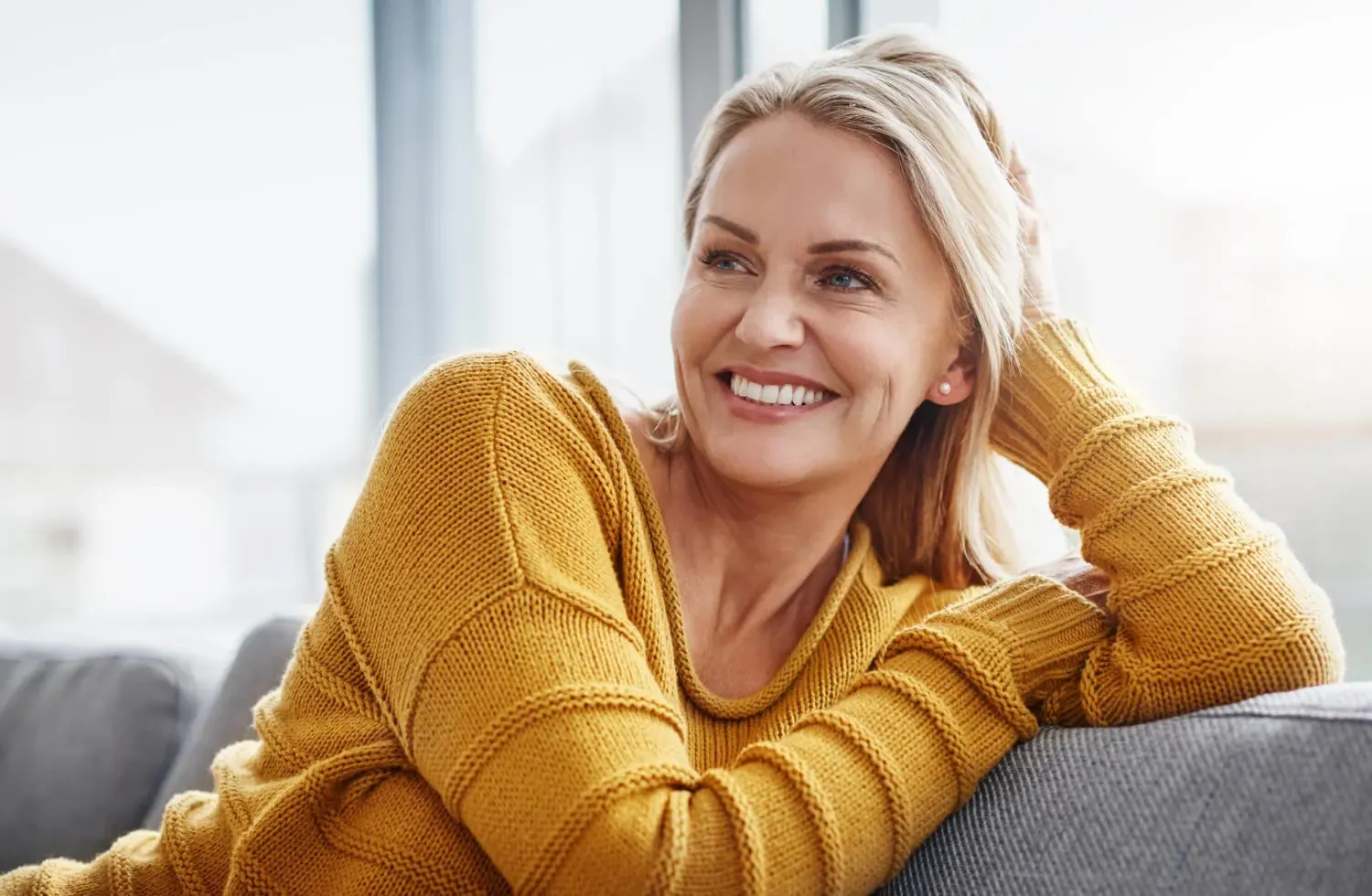 medical dermatology woman attractive-mature-woman-relaxing-sofa-home